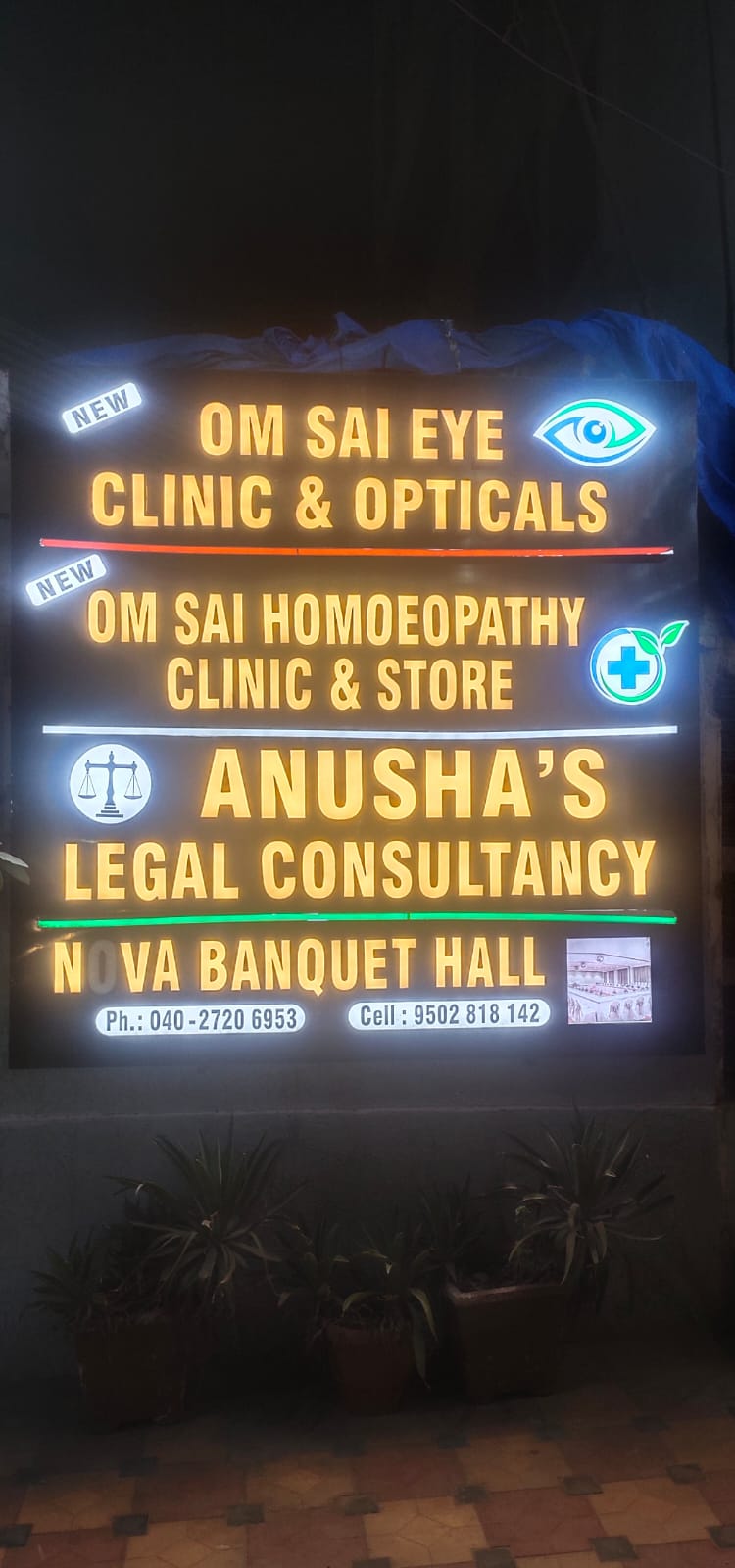 Om Sai Clinic illuminated signage at night